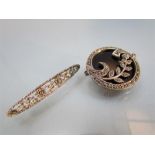 Two Marcasite set brooches. 1) Circular black Onyx with a silver 9.5 ribbon border and leaf design