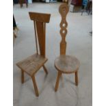 Two carved African Tripod high back chairs.