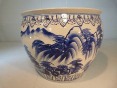 Large Chinese Blue and white fishbowl of large proportion. Decorated exterior of mountainous scenes,