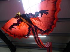 Large Chinese dragon kite with tail and wings.