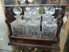 Mahogany and silverplated Tantalus marked P B & S. The top folding down which houses three cut glass
