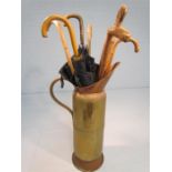 Large copper jug with selection of vintage walking sticks and umbrellas