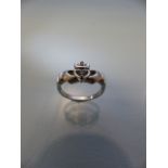 9ct "Heart in Hands" white gold ring with central stone (possibly aquamarine)