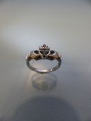 9ct "Heart in Hands" white gold ring with central stone (possibly aquamarine)