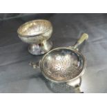 Continental silver. To include a Tea strainer with ebonised handle and a small condiment pot on