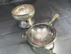 Continental silver. To include a Tea strainer with ebonised handle and a small condiment pot on