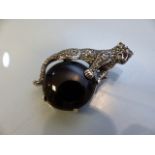 Silver and marcasite Cartier-style brooch/pendant of a puma sitting on a large Onyx stone