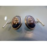 Pair of silver and enamel-set cuff links depicting sailing ships