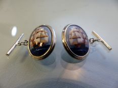 Pair of silver and enamel-set cuff links depicting sailing ships