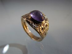 9ct Gold ring with floral scrolls and decoration set with an Amethyst.