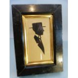 19th Century unsigned Silhouette of a suited Gentleman wearing a top hat. Mounted in an ebonised