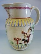 A 19th Century Staffordshrie Prattware jug decorated in relief with Men drinking in a Garden.