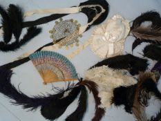 Selection of Ostrich Dress feathers, fan and a Middle Eastern headdress adorned with coins on a gold