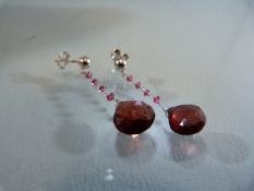 Pair of white gold and garnet drop earrings