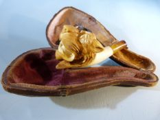 A 19th century cased meerschaum pipe modelled in the form of a lion/ tiger and with amber stem A/F