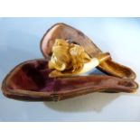 A 19th century cased meerschaum pipe modelled in the form of a lion/ tiger and with amber stem A/F