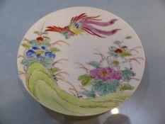 Chinese hand painted porcelain saucer/dish depicting a phoenix and flowers. Characters to reverse