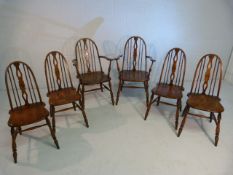 Set of six Elm and Beech Glenister dining chairs with stick backs. (Two include two carvers)