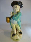 Early 19th Century Wood Type Pearlware Toby Jug of a standing man holding a pipe across is chest and