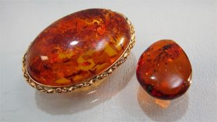 Baltic Amber brooch approx 30mm x 44mm wide with a yellow metal surround and pin. Together with a