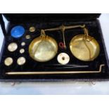 Set of boxed brass jewellery scales and weights