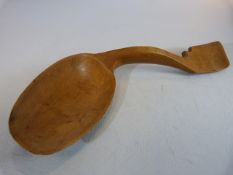 Treen boxwood Cawl spoon of curved form. Dated 1877. With writing verso. Approx 16.5cm.