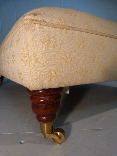 Large low upholstered footstool on brass castors - Image 3 of 5