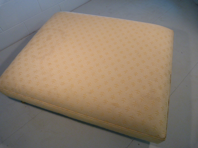 Large low upholstered footstool on brass castors - Image 4 of 5