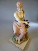 Neale & Co creamware figure of a man sat upon a tree stump with a black bird holding a stone