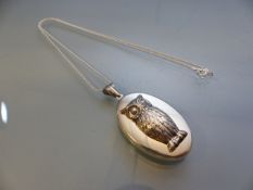 Silver locket with embossed owl decoration on silver chain