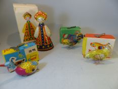 Four clockwork Russian Toys in original packaging with keys - Two chickens, a swimming duck and a