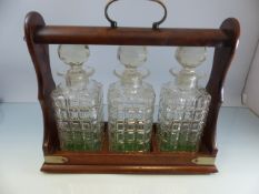 Oak cased Tantalus with brass handle. Three moulded glass decanters. Comes with key Lock A/F