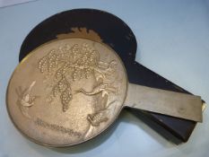 A Japanese relief decorated hand mirror of the Meji period depicting Cranes &Cherry Blossom and