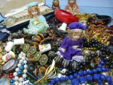 Small collection of costume jewellery and four small porcelain dolls.