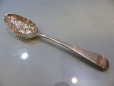 Late Georgian silver berry spoon, with repousse bowl depicting fruit and foliage with engraved