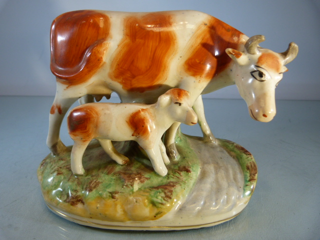 Early Staffordshire cow and her calf crossing the Road. Sponge decorated base.