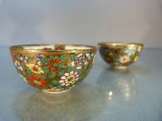 Two miniature 20th century Sake cups adorned with floral detailing