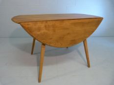 Blonde Ercol drop leaf dining table on stick legs