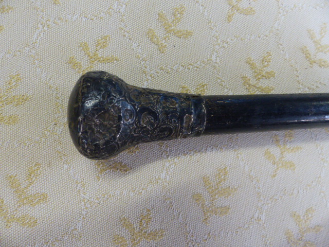 Hallmarked silver topped cane, London. The Silver top having trailing floral detailing on an - Image 2 of 2