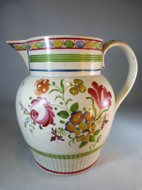 Early 19th Century English Creamware staffordshire jug decorated with Polychrome flowers and