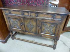 Arts and Crafts Oak dresser with carved panels to cupboard doors