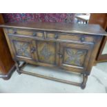 Arts and Crafts Oak dresser with carved panels to cupboard doors