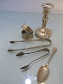 Collection of Silver items to include a two napkin rings, two sugar tongs, a silver filled candle