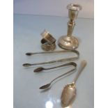 Collection of Silver items to include a two napkin rings, two sugar tongs, a silver filled candle