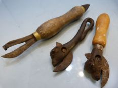 Antique Bull head can opener, one other and a turned wooden opener