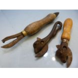 Antique Bull head can opener, one other and a turned wooden opener