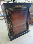 Victorian ebonised music cabinet with glazed door. Gilded supports and decoration