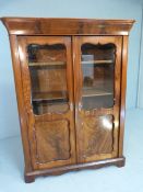 Flame mahogany display cabinet with shaped frames to glass windows