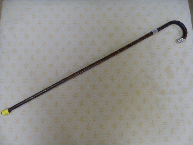 Hallmarked silver banded cane with mounted silver handle. London by J Howell & Co Ltd