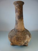 Central American early pottery 'Bottle' vase on Tripod feet. Circular and geometric patterns.